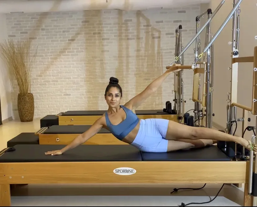 Sepideh demonstrating a side-lying exercise on the Reformer
